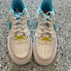 Nike Kids White Sneakers with Teal Swoosh and Yellow Accents